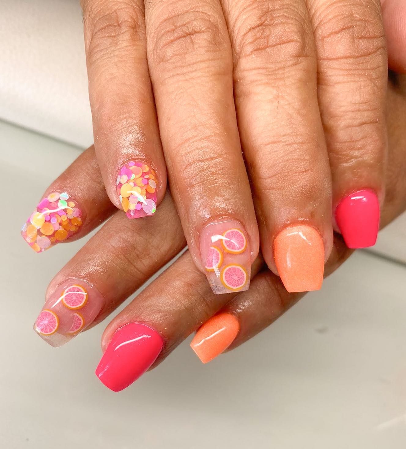 Summe rnails with bright colors and tropical flower on two nails