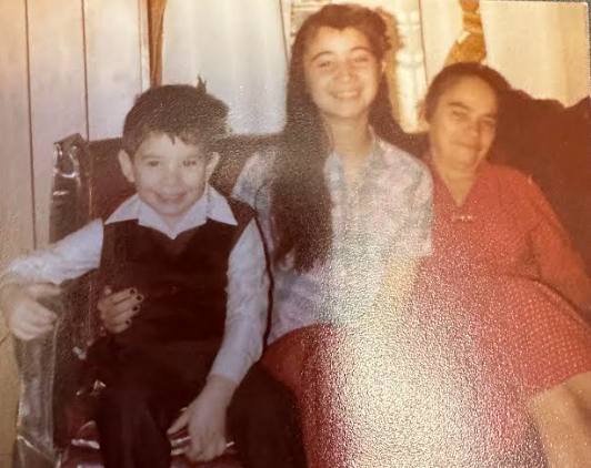 Enid DeCastro (center) with her brother and grandmother.
