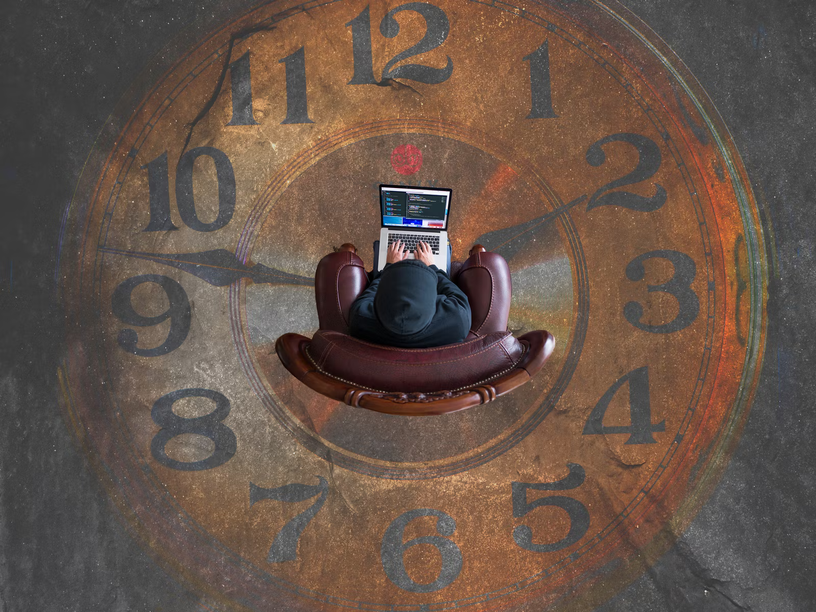 A seated figure works around the clock representing the risk of work stress