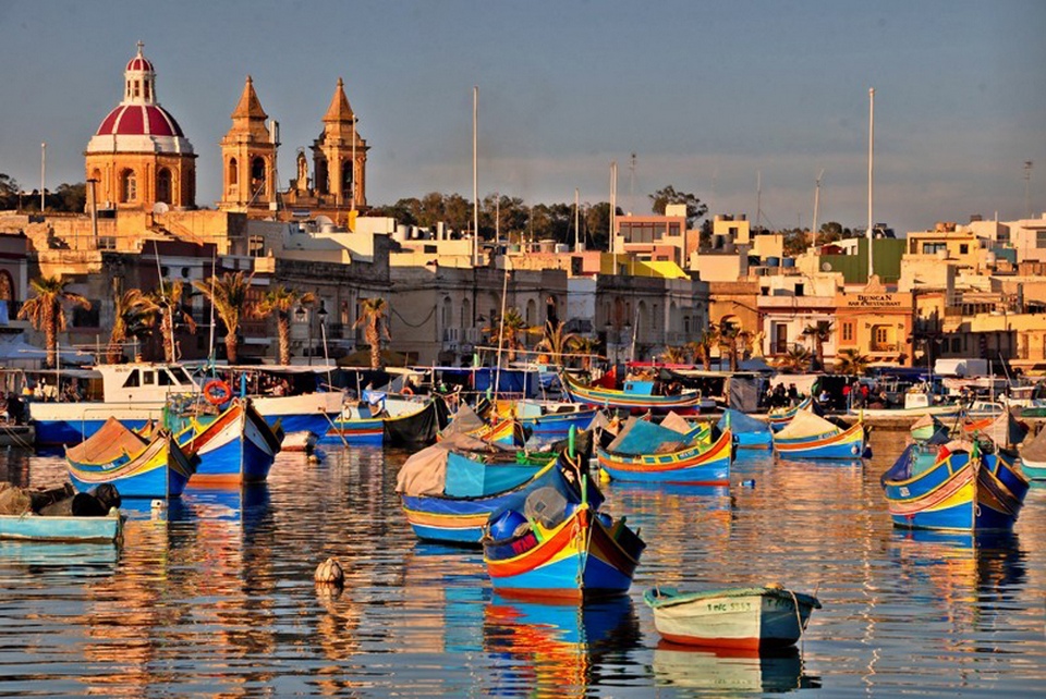 Colourful fishing boats lining the harbourfront in Marsaxlokk during the Sunday Market