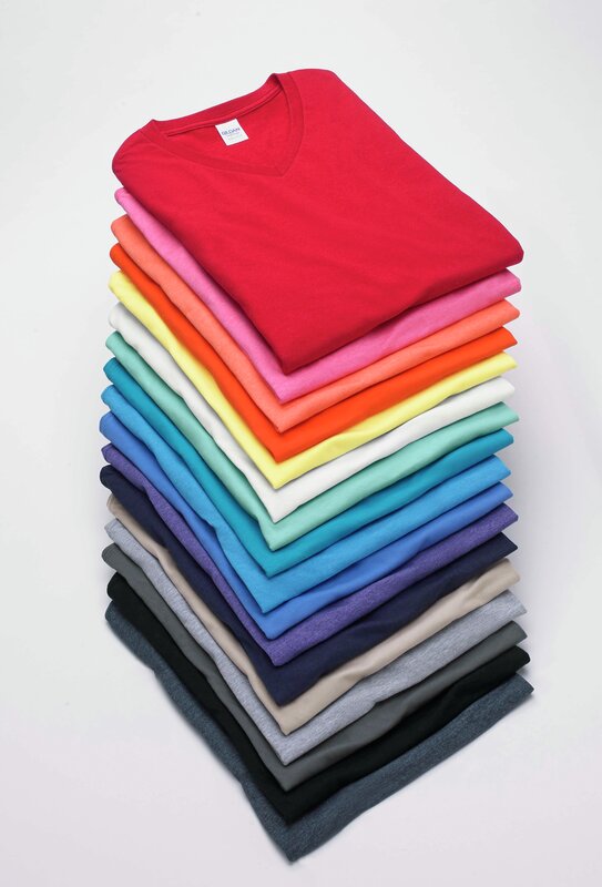 Gildan G640 Softstyle and H000 Hammer shirts folded and stacked in rainbow order.