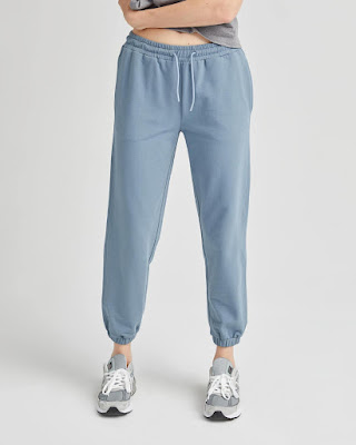 Bottom half of a model wearing light blue mostly traditional design sweatpants.