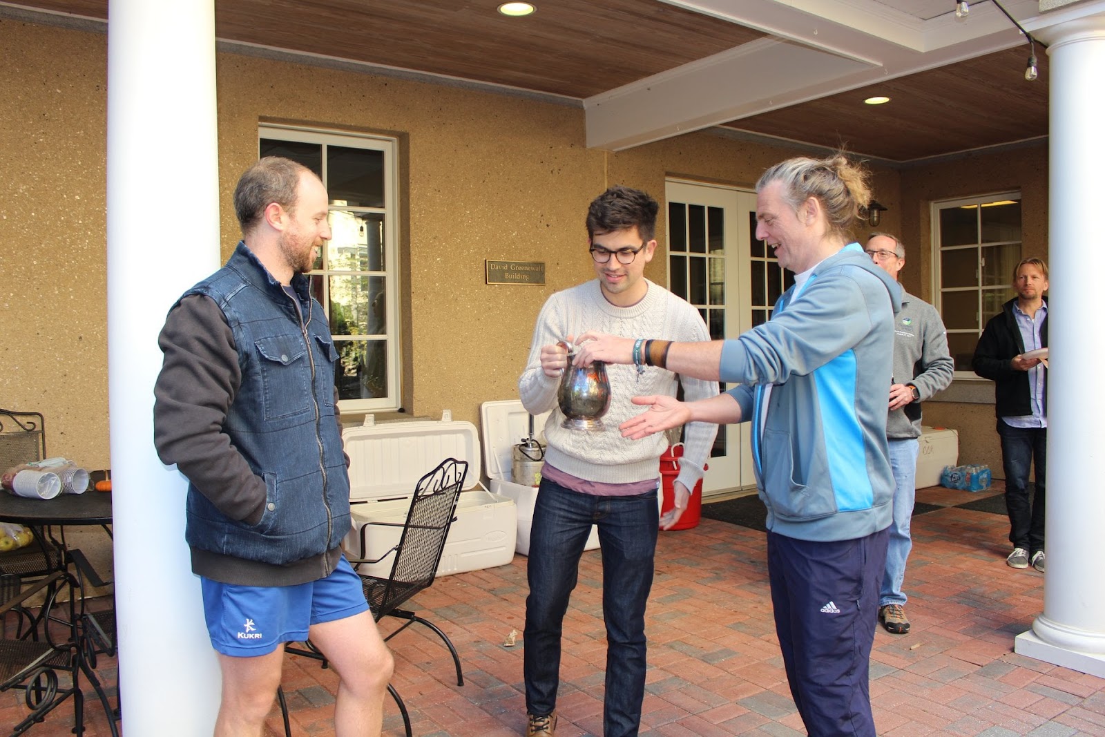 From left to right: Traditionally, the winning team will drink from the historic mud cup, pictured here. 