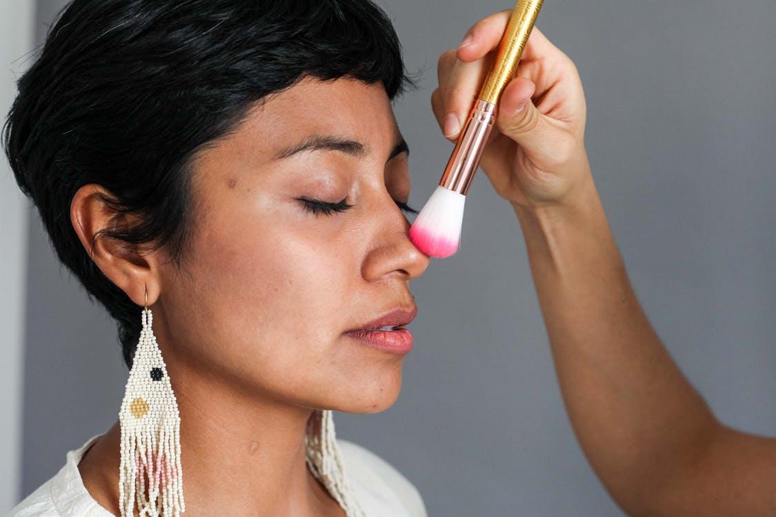 Woman in White Shirt Holding Makeup Brush