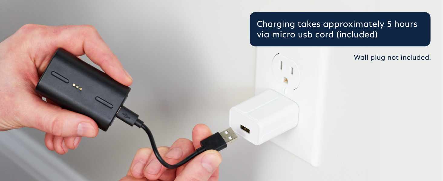 A person holding the Outdoor Camera battery with a charging cable, plugging it into a USB power brick.