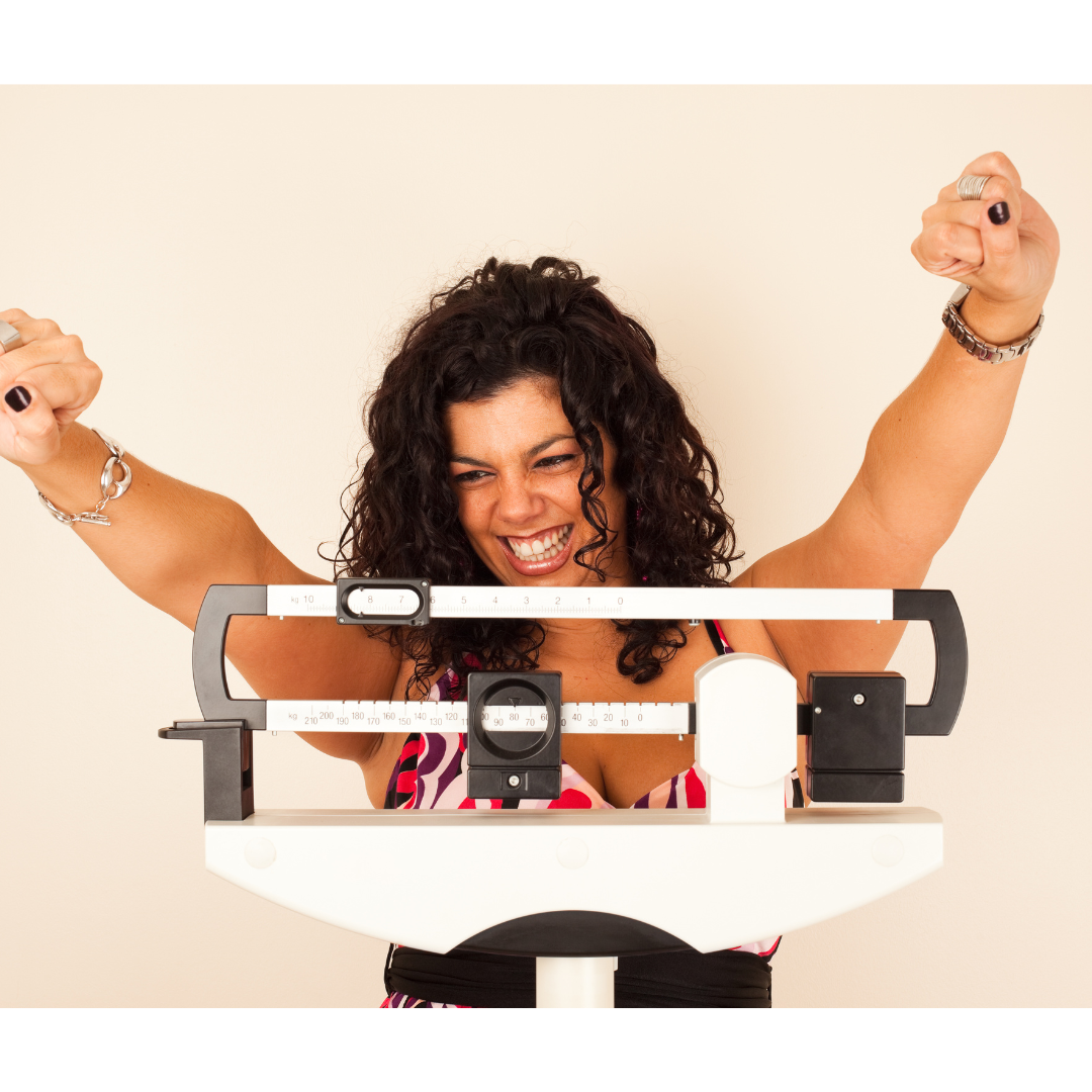 Breastfeeding woman checking her weight loss excitedly on the scale