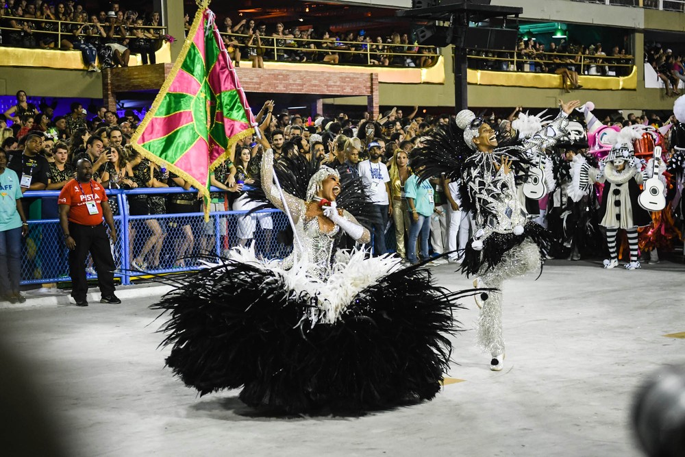 Rainha desfilando e dançando com passista de uma das escolas de samba do rio de janeiro.