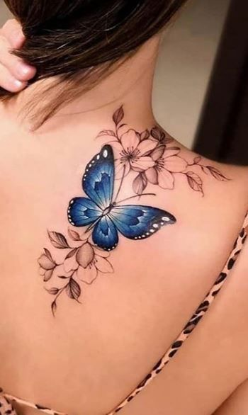 lady wearing butterfly and flower tattoo on her back shoulder