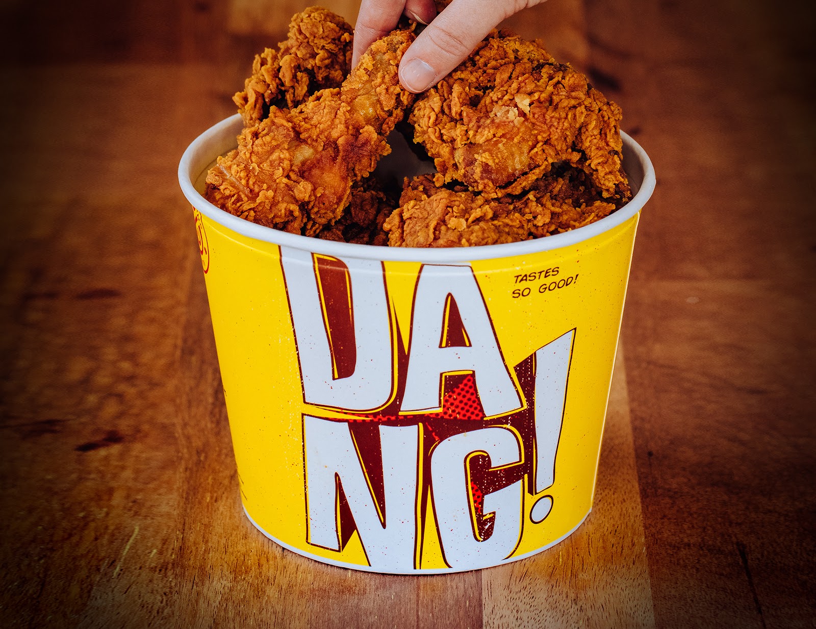 The Chicken Treat bucket packaging is designed in the brand's comic book style and features the word DANG