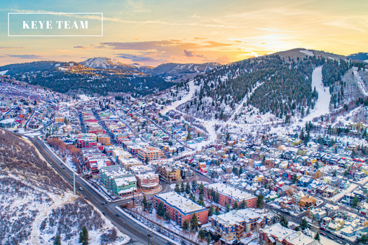 Aerial shot of Park City, Utah in the winter. Image of small homes filled with snow and a beautiful sunset.