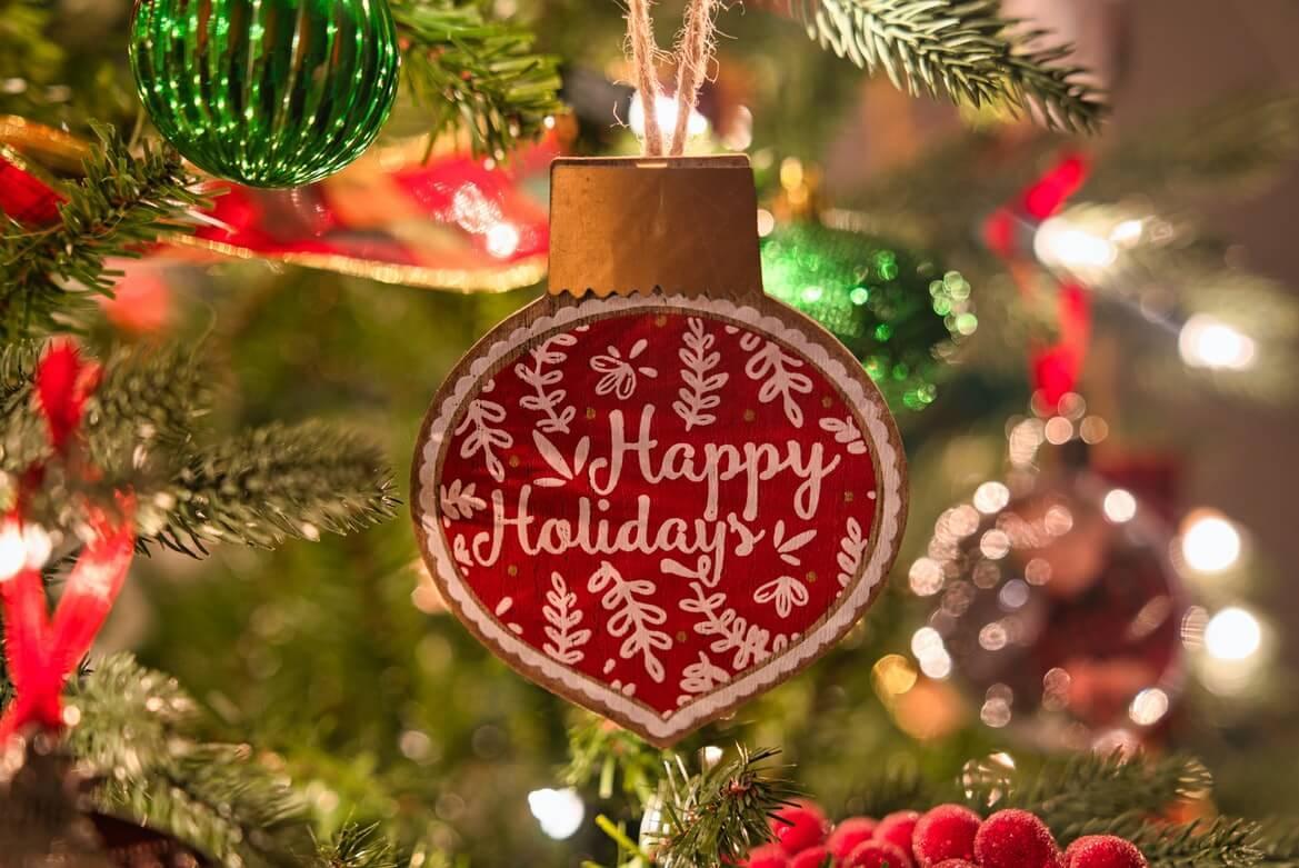 Happy holidays Christmas ornament on tree
