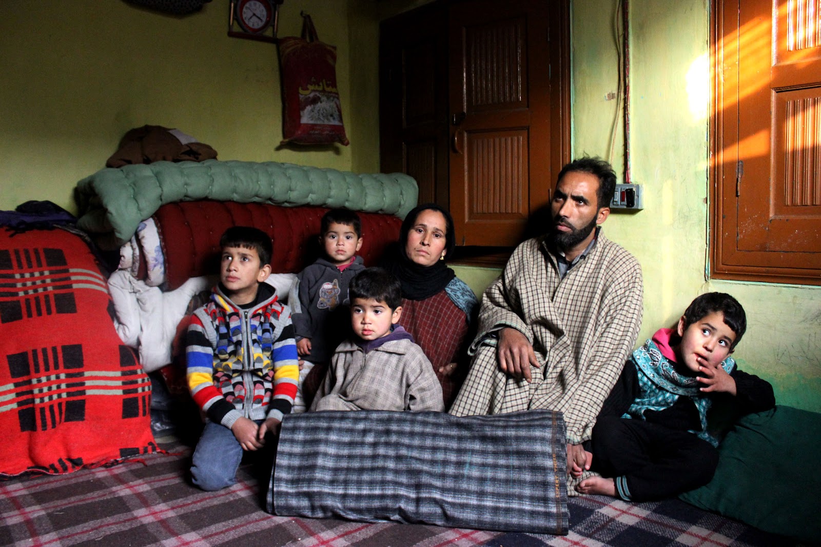 A family living in a single room provided by their neighbor after their house was turned into rubble by the devastating September floods at Bangidar in south Kashmir’s Anantnag district.jpg
