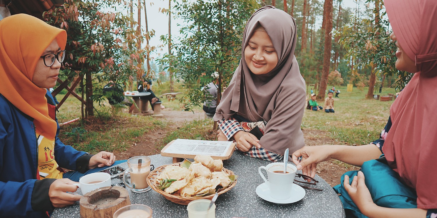 three Islamic women enjoying a meal outdoors
