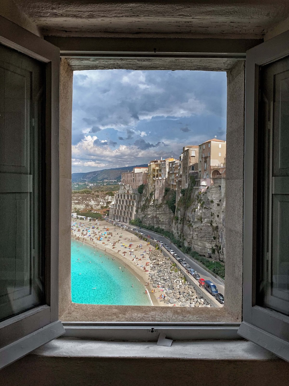 off the beaten path Italy, Tropea, window with a view, beach, buildings on cliff