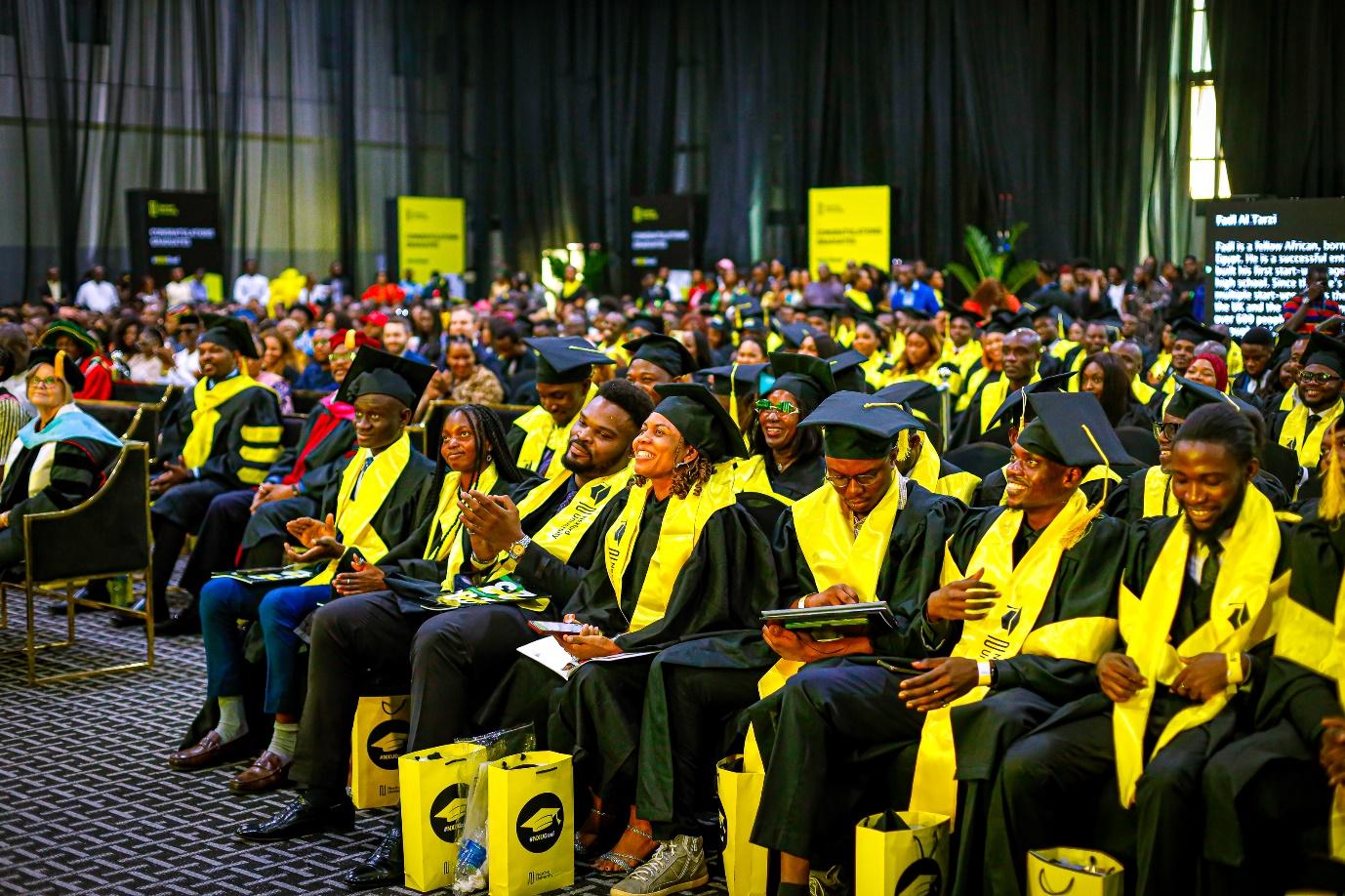 A group of people in graduation gowns and caps

Description automatically generated