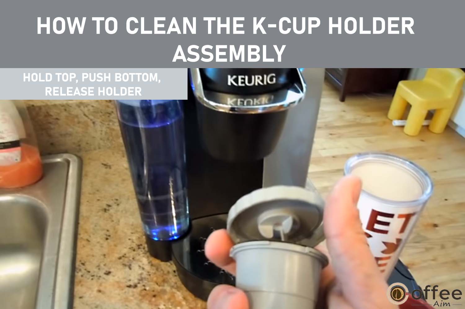 To release the K-Cup Holder Assembly, hold the top of the holder with one hand while pushing up from the bottom with the other hand until it detaches.