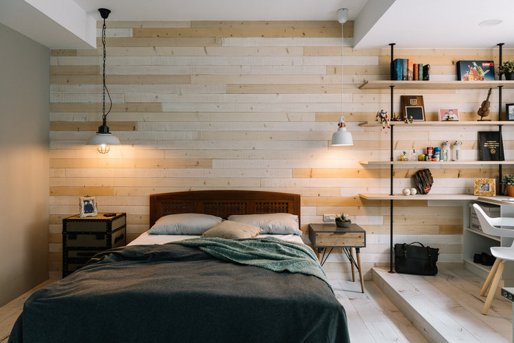 Industrial style bedroom with exposed iron bars and wooden walls and flooring