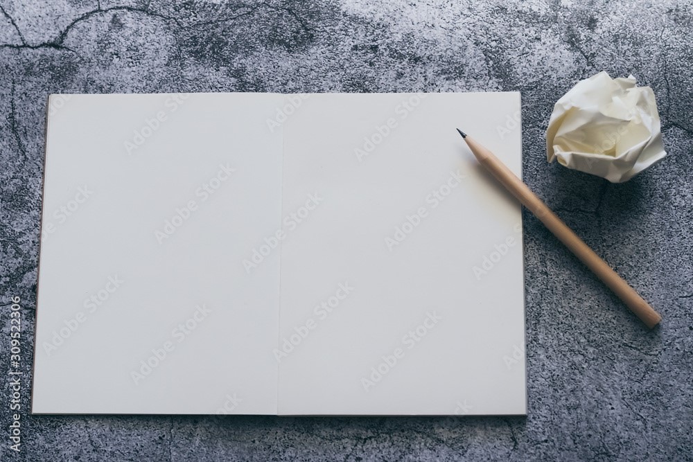 White blank page of notebook, diary or journal with pencil for writing text or message and ideas on concrete background with copy space. Minimalism lifestyle of business and education concept