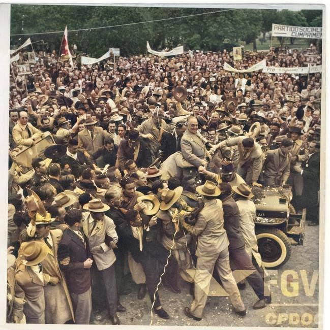 A group of people posing for a photo in front of a crowd

Description automatically generated