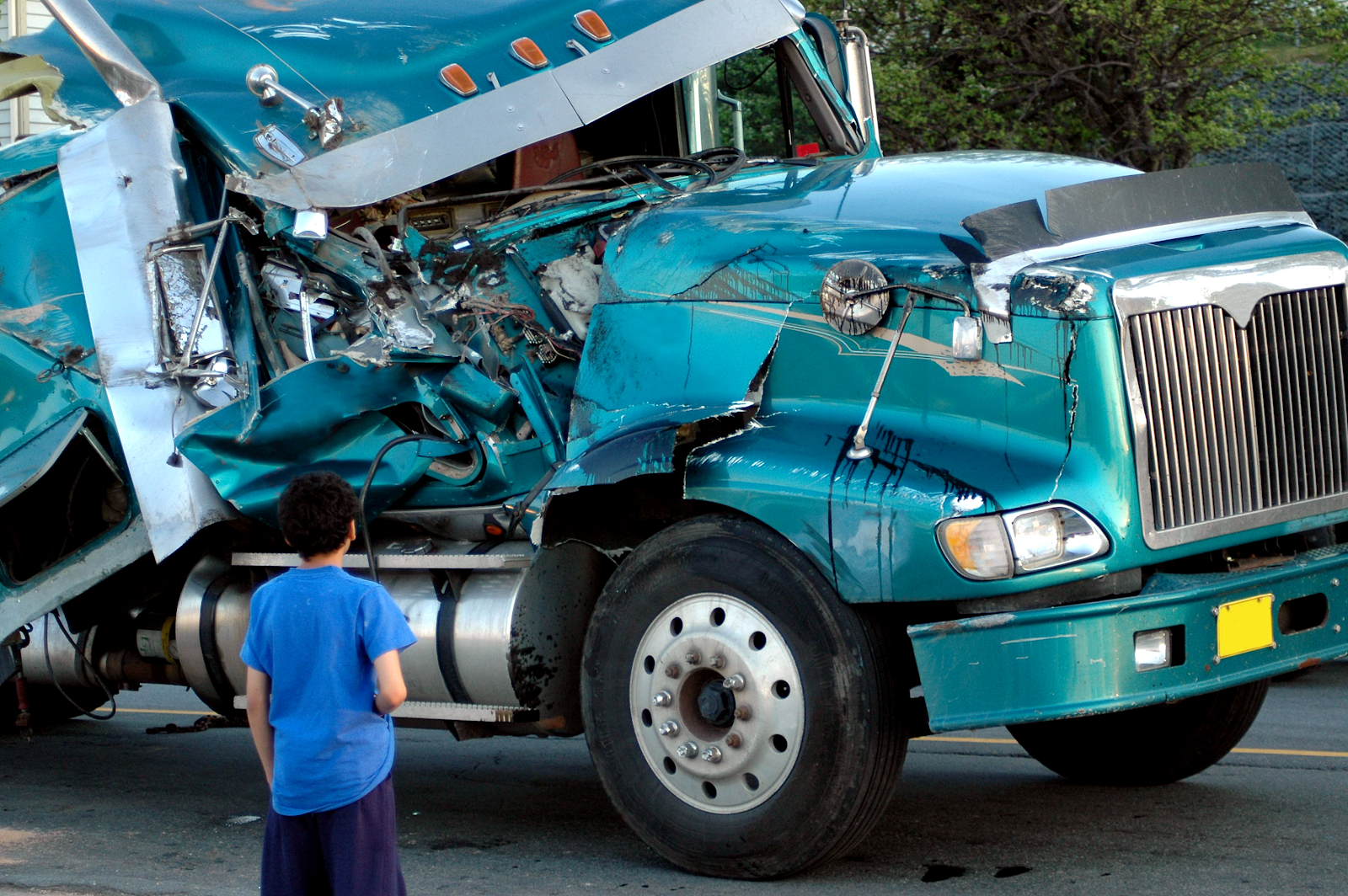 damaged truck after a virginia beach truck crash, truck driver looking at the damages