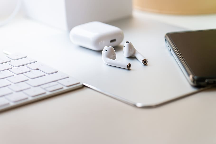 This image shows the Apple AirPods 2nd Generation with its charging case and mobile.