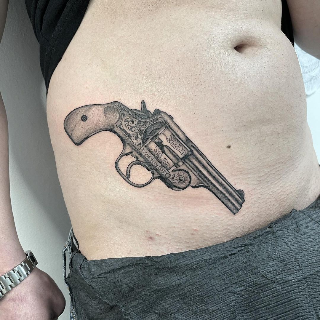 Wood Cut Gun Tattoo On Waist 