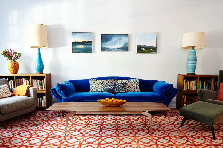 Colorful retro living room with bright couches and a geometric patterned carpet