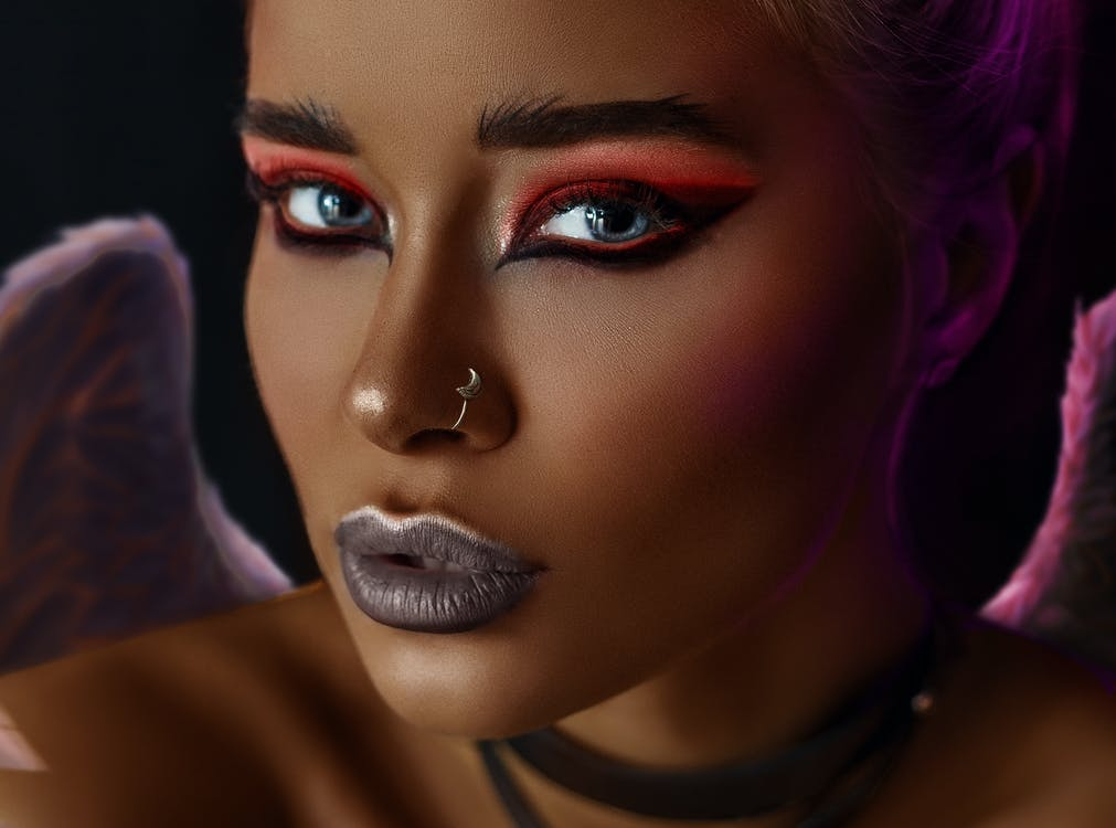 a bold, winged liquid eyeliner look with red eyeshadow