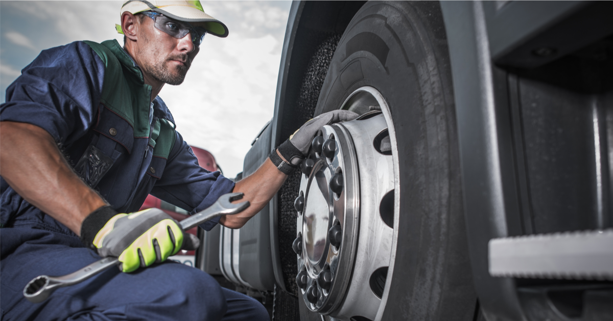 Man doing wheel maintenance for a truck service interval