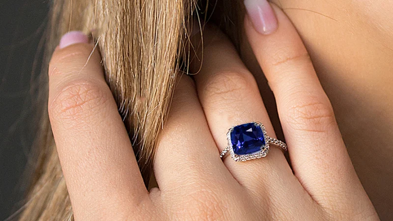 a woman wearing blue sapphire ring