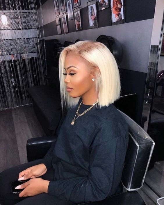 a lady wearing blunt cut bob blonde hairstyle