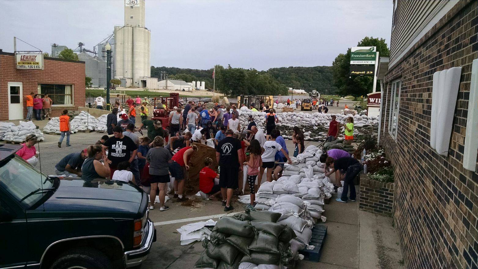 Elkader, Iowa residents build a sandbag wall to prevent flooding.