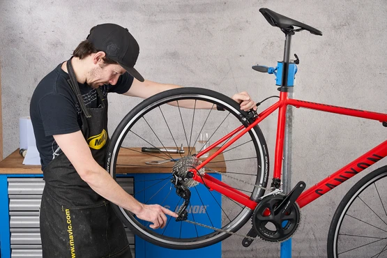 Pedal by hand to test that your chain is able to shift into all the gears including the low and high gears.
