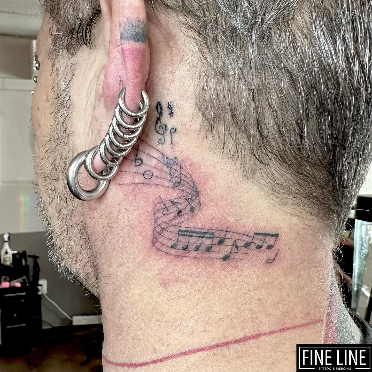 Musical Notes Behind The Ear Tattoo