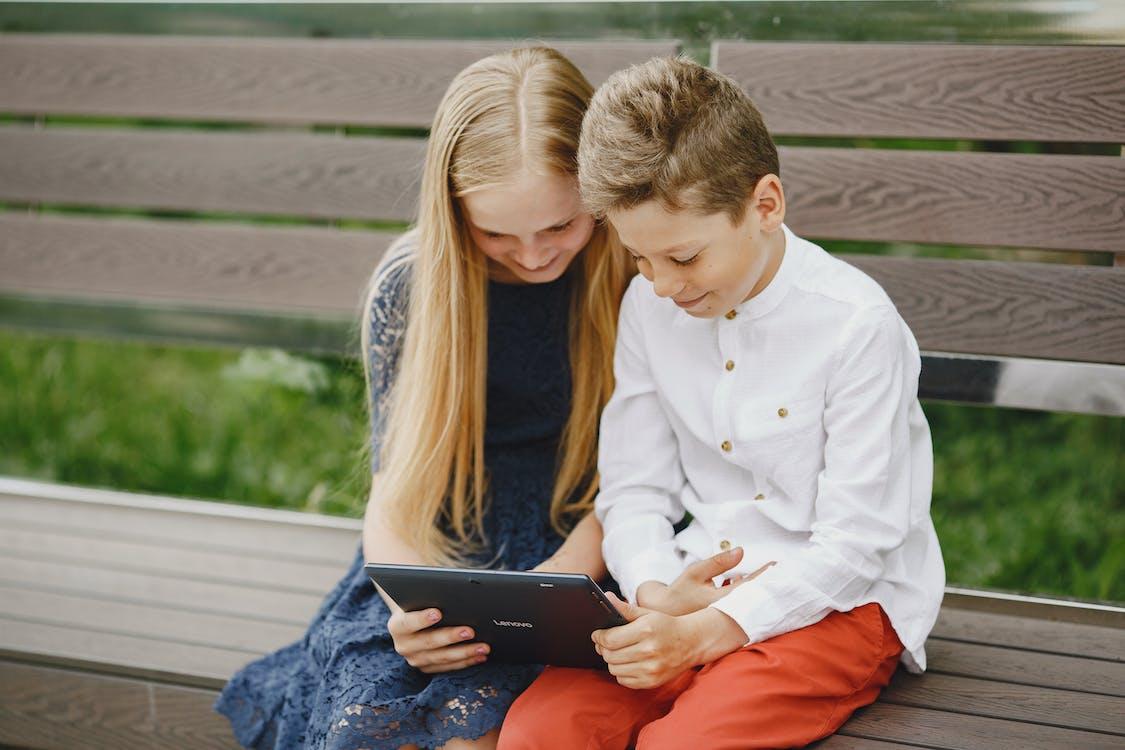 Free Photo of a Boy and a Girl Watching on a Tablet Stock Photo