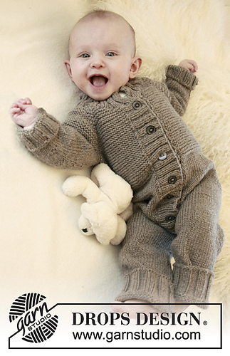 happy baby wearing a tan buttoned romper on fur blanket