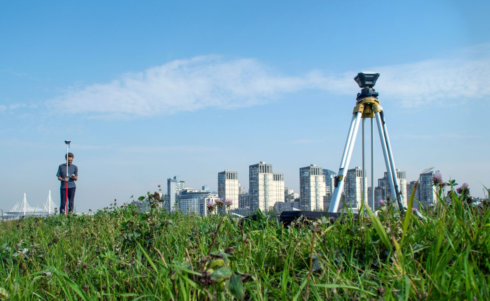 Surveyor taking photos with a cityscape background