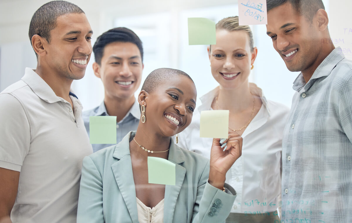 Revenue cycle management medical billing: employees working together and writing on sticky notes