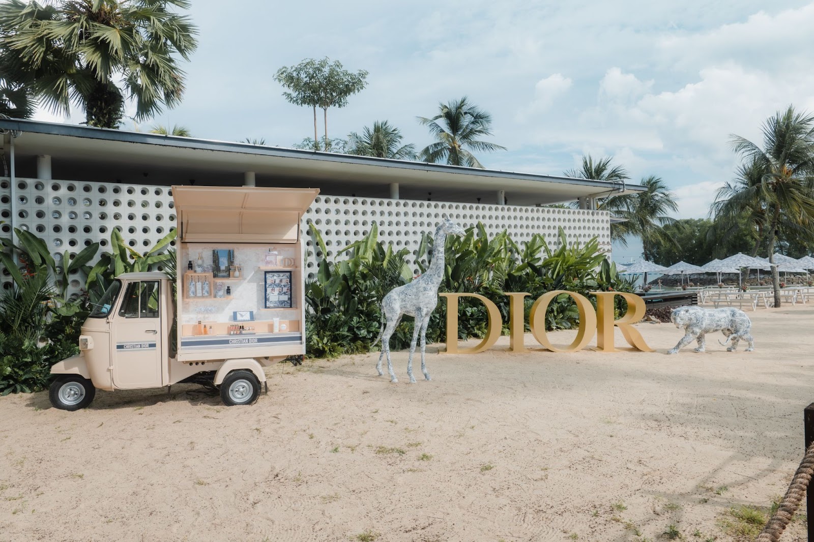 The Tanjong Beach Club, Singapore entrance done up for the Dior Dioriviera event with animal sculptures and a Dior auto-rickshaw.