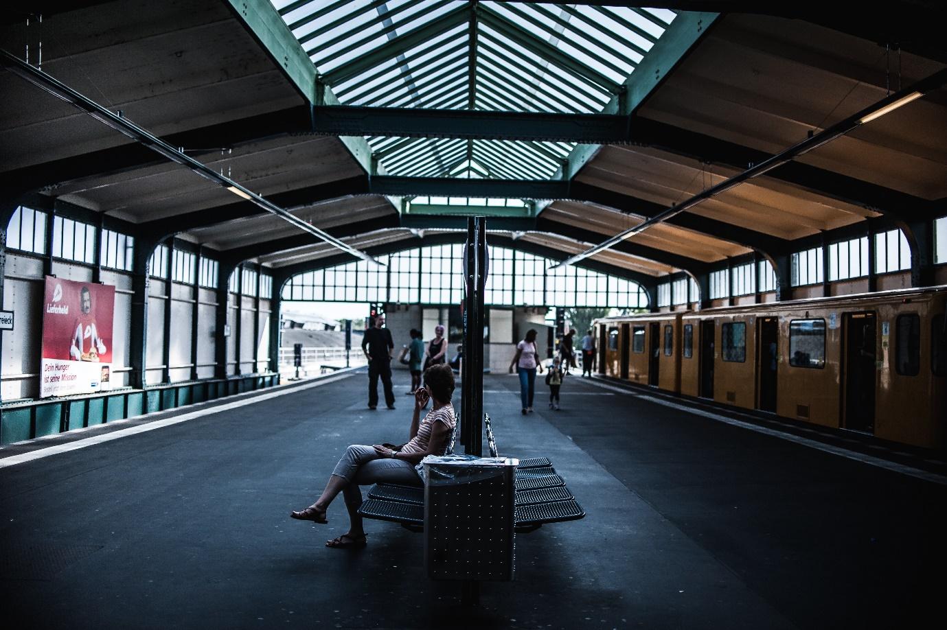 A person sitting on a bench in a train station

Description automatically generated with medium confidence