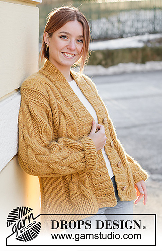 woman wearing a chunky cable knit cardigan