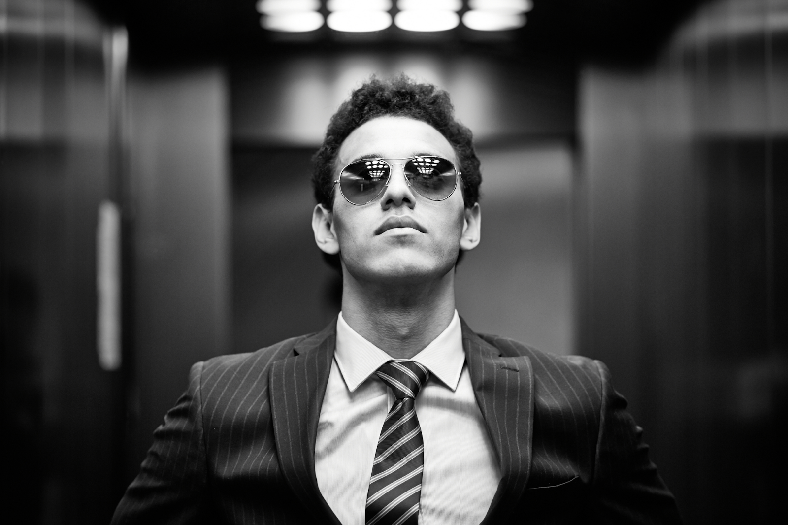 man in suit and glasses in an elevator