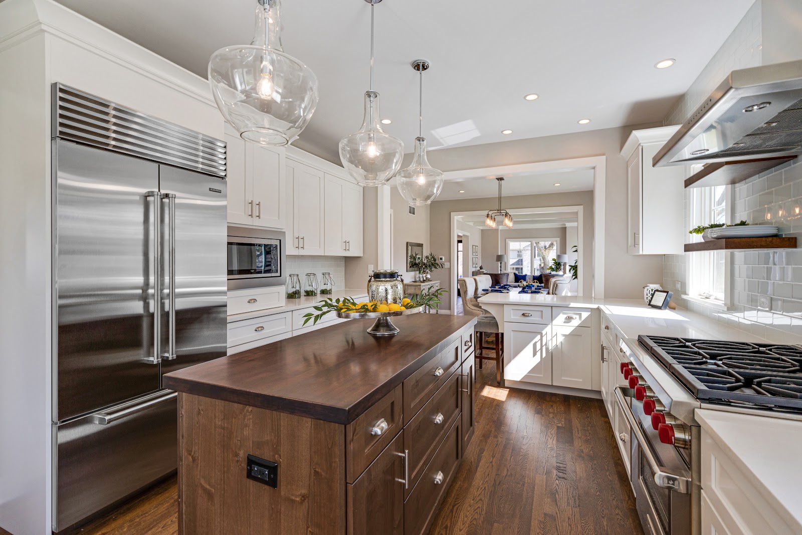 Modern kitchen design with white cabinets and a natural wood finish island from Wood Harbor, a KCMA certified cabinet builder. Featuring quartz countertops and energy star appliances.