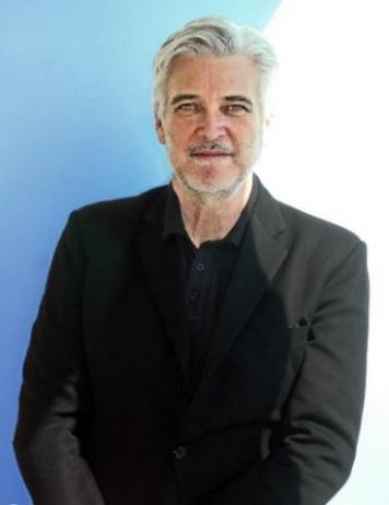 A person wearing a suit and tie
Description automatically generated