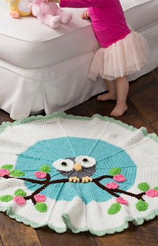 circular crochet owl blanket on floor