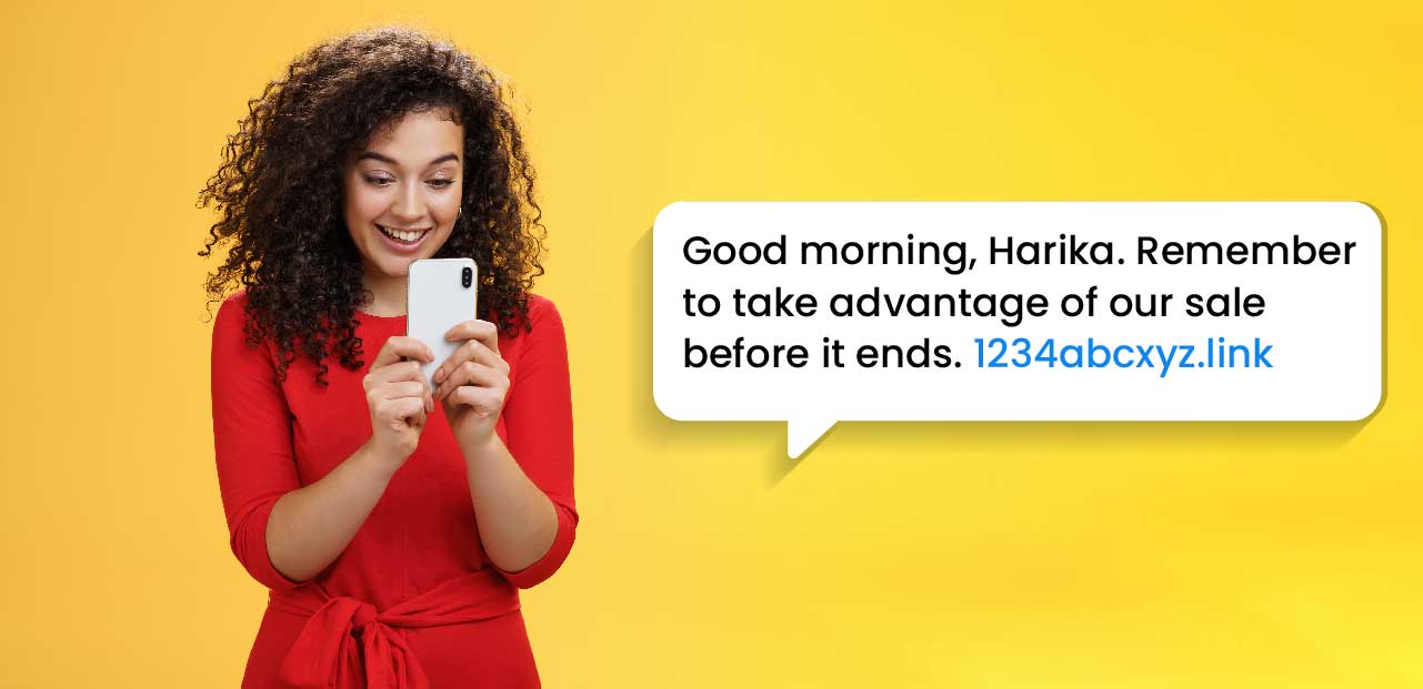 Timing is everything | A female in a red dress in a yellow background, excitedly smiles at a timely promotional SMS message she just received.