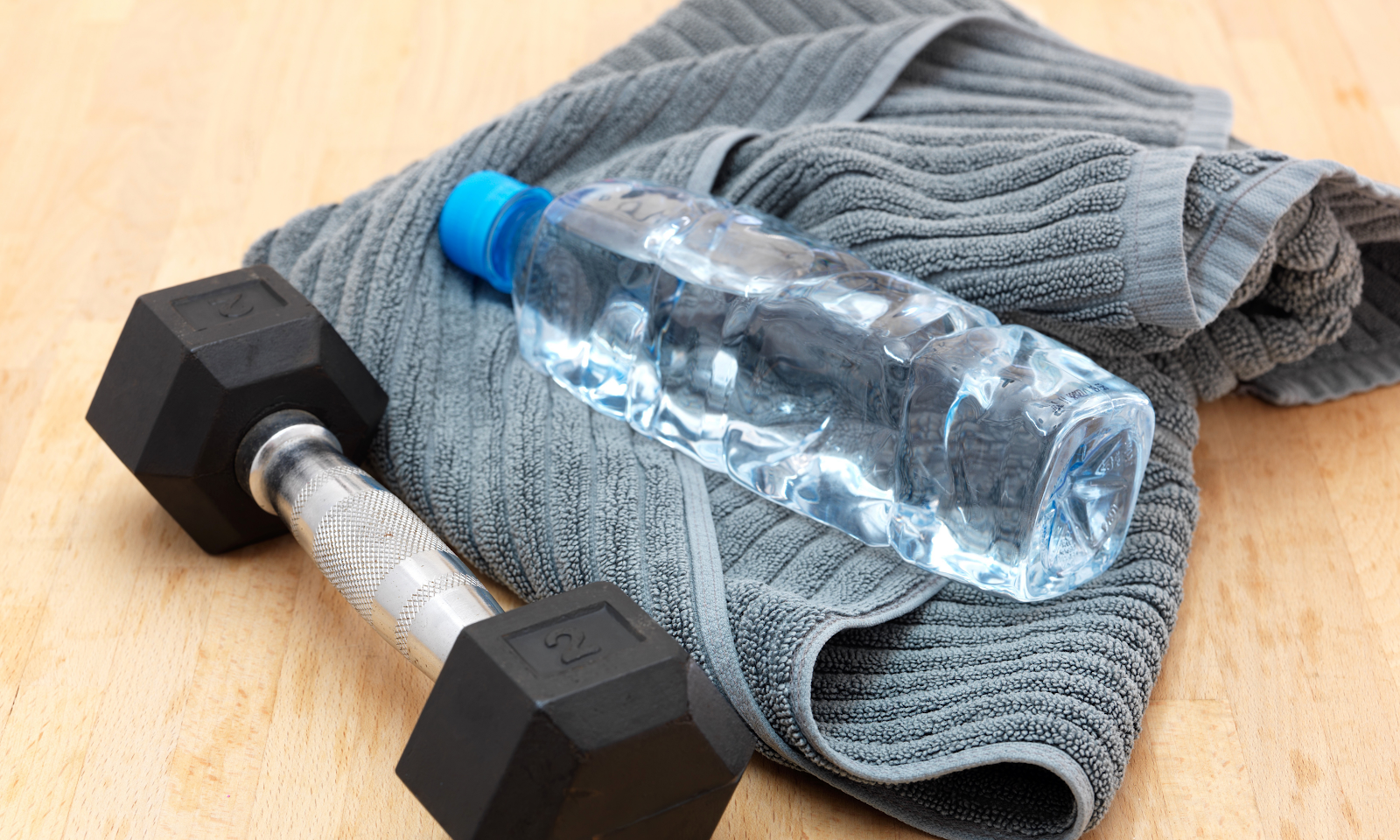 Two lb weight and water bottle with towel for exercise for metabolic weight loss