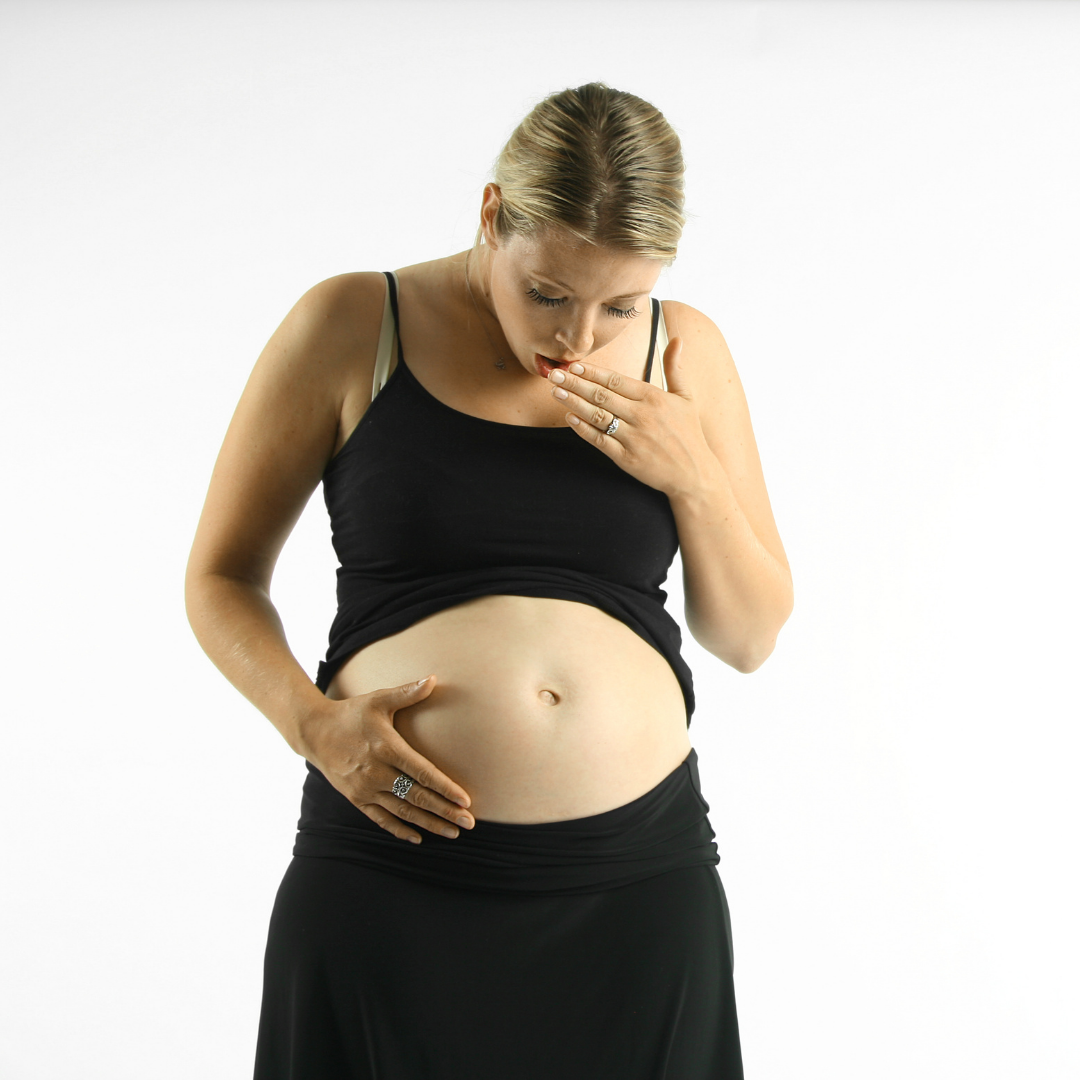 A pregnant woman acts surprised while using breastfeeding as birth control