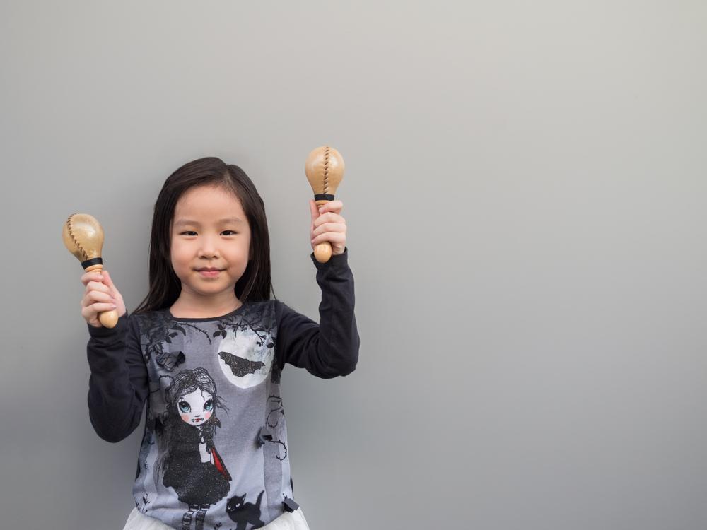 ../../Desktop/stock-photo-little-asian-child-play-the-maracas-gray-background-582763411.jpg