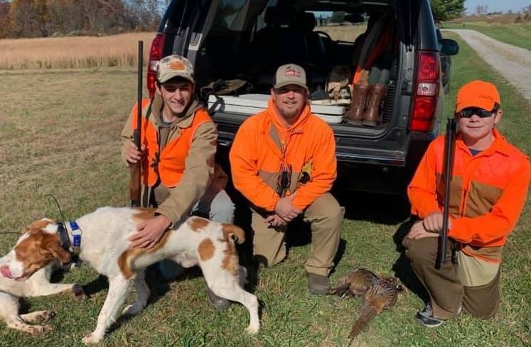 A group of people in orange vests with a dog

Description automatically generated with low confidence